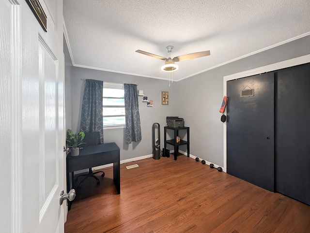 office featuring crown molding, hardwood / wood-style floors, ceiling fan, and a textured ceiling