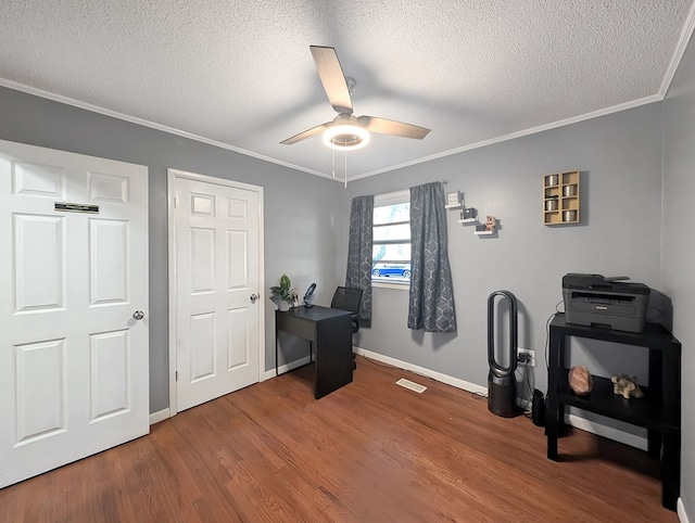 office space featuring hardwood / wood-style flooring, ceiling fan, ornamental molding, and a textured ceiling