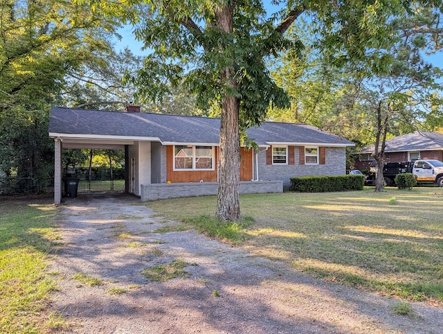 ranch-style house featuring a carport and a front lawn