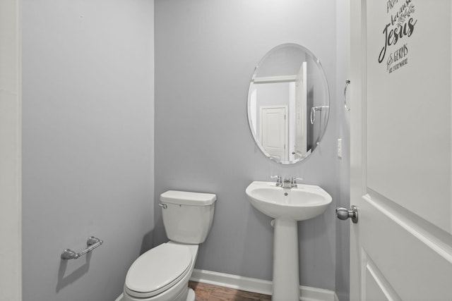 bathroom featuring toilet, hardwood / wood-style flooring, and sink