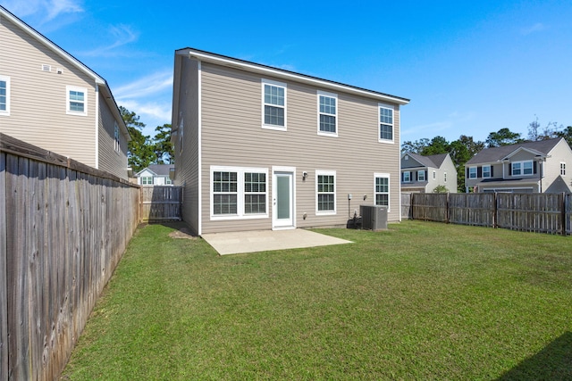 rear view of property with a patio, central air condition unit, and a lawn