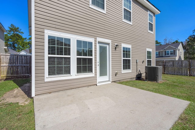 back of house featuring a patio, a yard, and central AC unit