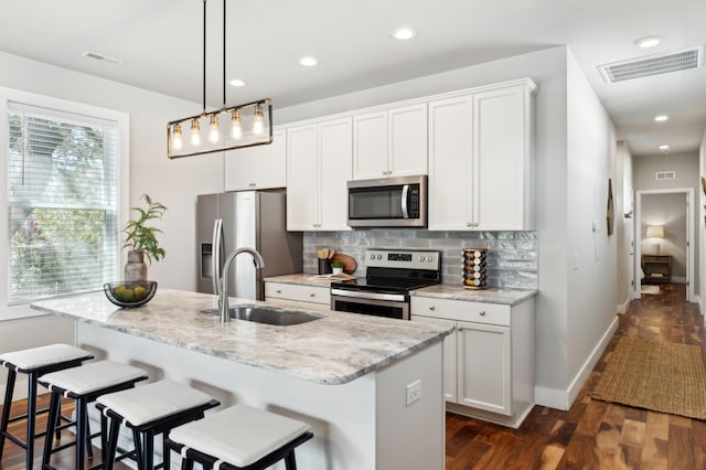 kitchen featuring a sink, visible vents, tasteful backsplash, and appliances with stainless steel finishes