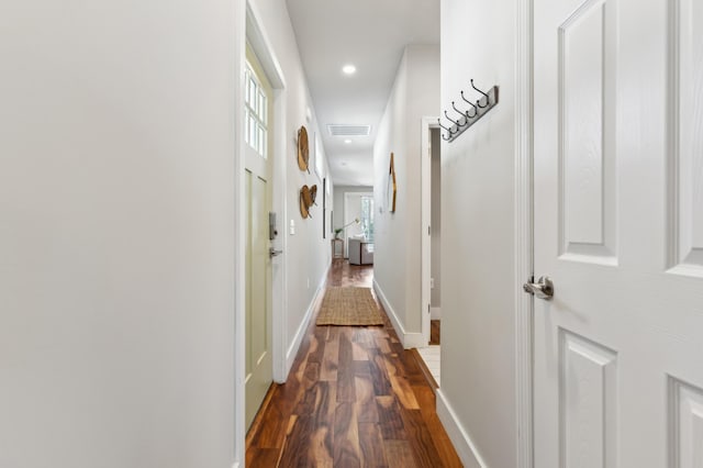 hall with dark wood-type flooring, recessed lighting, visible vents, and baseboards