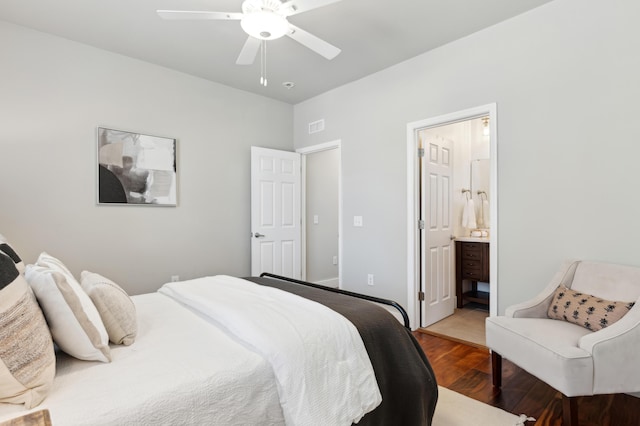 bedroom with visible vents, ensuite bath, a ceiling fan, and wood finished floors