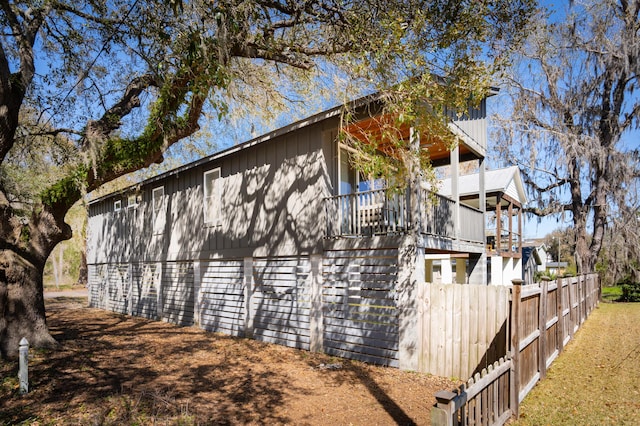 view of side of property featuring fence