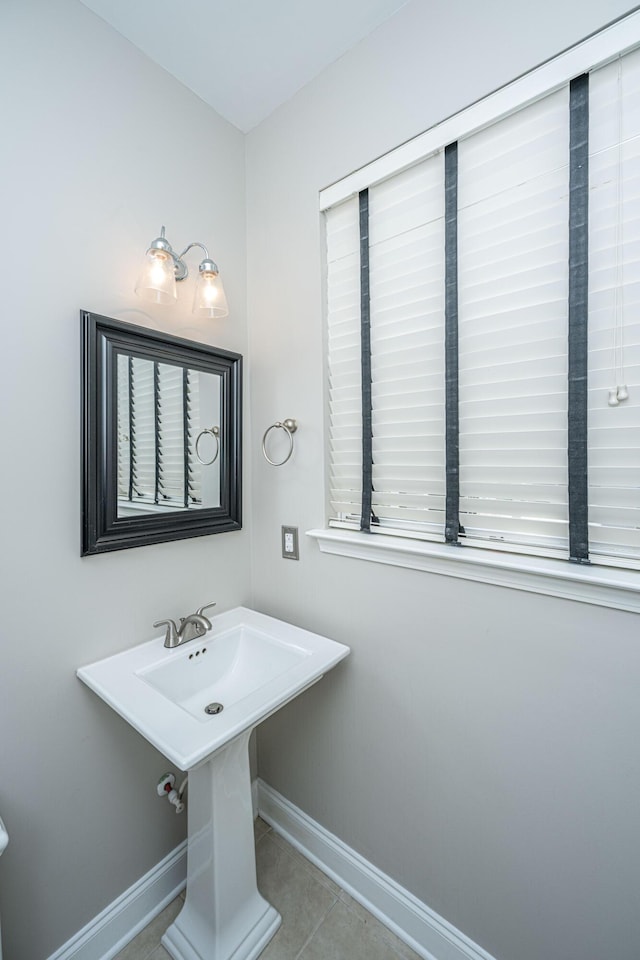 bathroom with baseboards and tile patterned floors