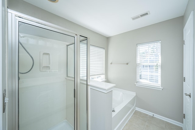 full bathroom featuring visible vents, baseboards, a garden tub, tile patterned flooring, and a shower stall