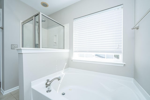 full bath with tile patterned floors, a garden tub, and a shower stall