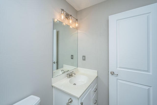 half bath with vanity and toilet