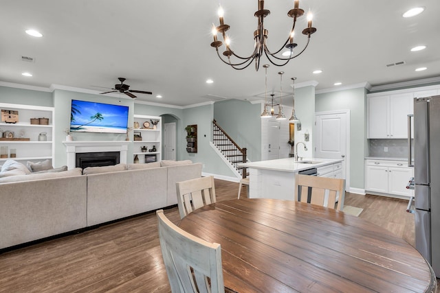 3873 Hanoverian Dr, Mount Pleasant, SC 29429 - dining space with ornamental molding, stairway, ceiling fan, wood finished floors, and recessed lighting