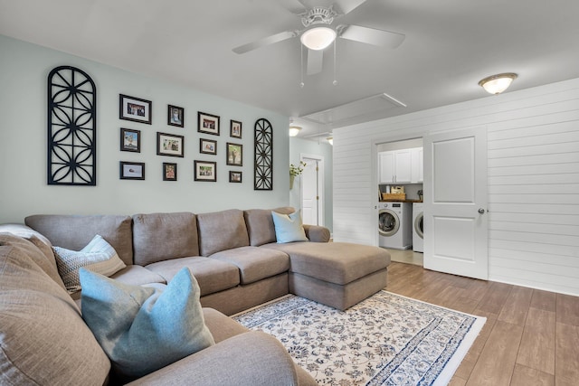 3873 Hanoverian Dr, Mount Pleasant, SC 29429 - living room with attic access, washing machine and dryer, ceiling fan, light wood finished floors, and wooden walls