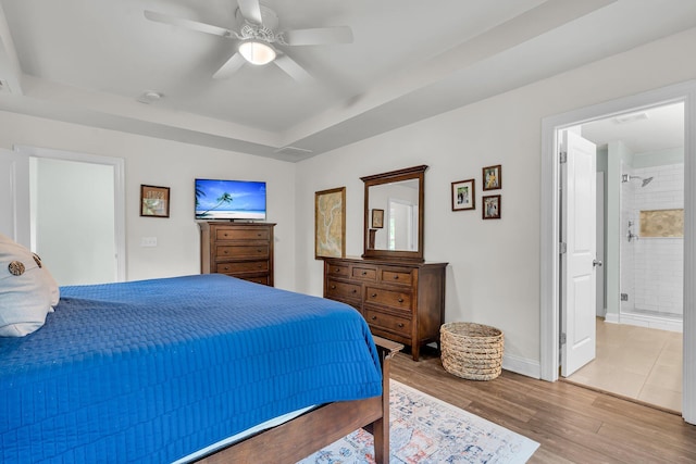 3873 Hanoverian Dr, Mount Pleasant, SC 29429 - bedroom featuring light wood finished floors, a tray ceiling, a ceiling fan, baseboards, and connected bathroom