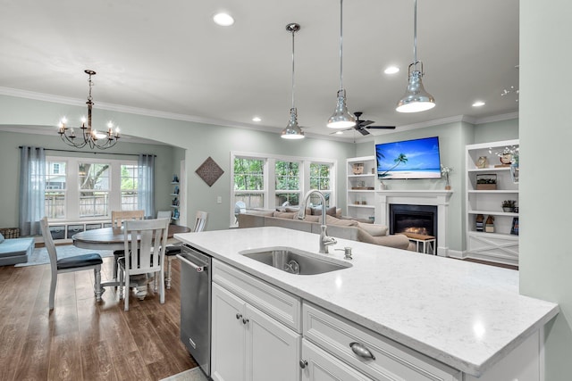 3873 Hanoverian Dr, Mount Pleasant, SC 29429 - kitchen featuring a sink, open floor plan, dishwasher, a glass covered fireplace, and crown molding