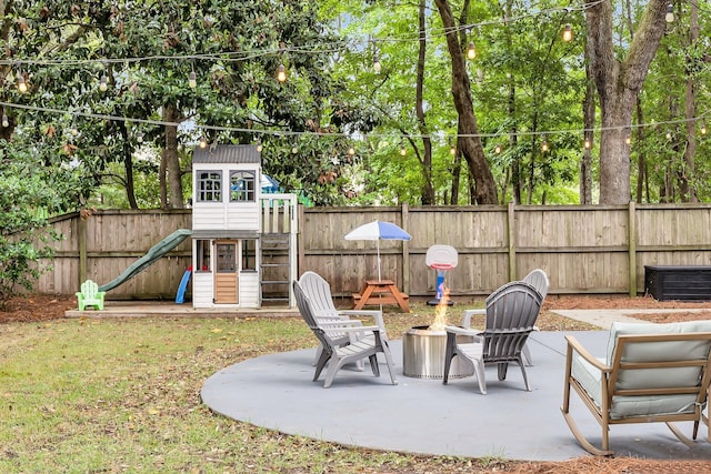 3873 Hanoverian Dr, Mount Pleasant, SC 29429 - fenced backyard with a playground, a patio area, a fire pit, and view of scattered trees