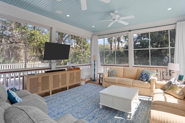 sunroom / solarium with a ceiling fan