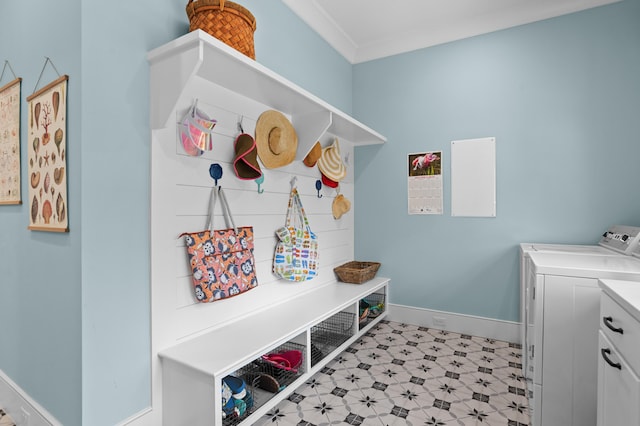 mudroom featuring baseboards, crown molding, washer and clothes dryer, and light floors