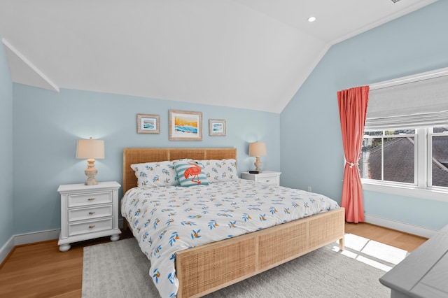 bedroom featuring lofted ceiling, recessed lighting, baseboards, and wood finished floors