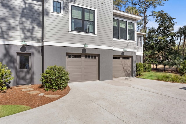 view of home's exterior with driveway, a garage, and stucco siding