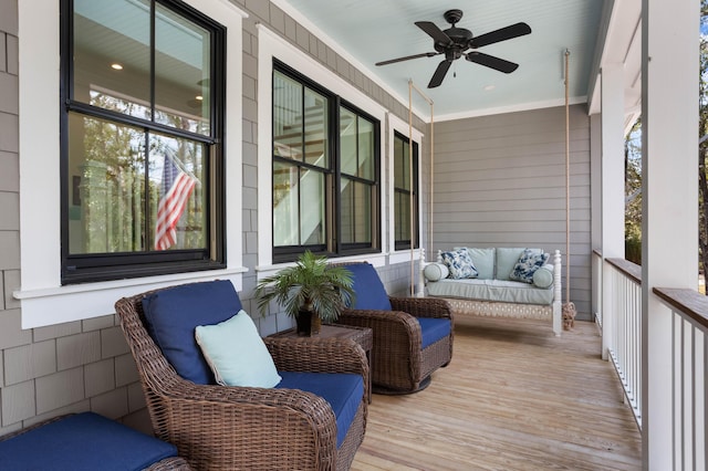 wooden terrace with a porch, ceiling fan, and an outdoor hangout area