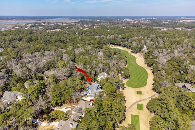 drone / aerial view with a wooded view and golf course view