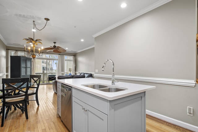 81 Sandbar Ln Unit 23, Folly Beach, SC 29439 - kitchen with stainless steel dishwasher, crown molding, a center island with sink, light countertops, and light wood-style flooring