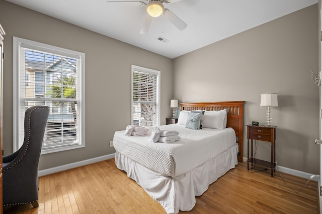 81 Sandbar Ln Unit 23, Folly Beach, SC 29439 - bedroom featuring hardwood / wood-style floors, multiple windows, and ceiling fan
