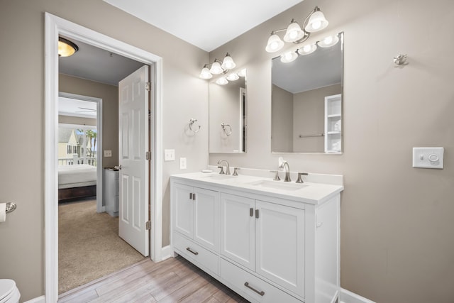 81 Sandbar Ln Unit 23, Folly Beach, SC 29439 - bathroom with double vanity, wood finished floors, and connected bathroom