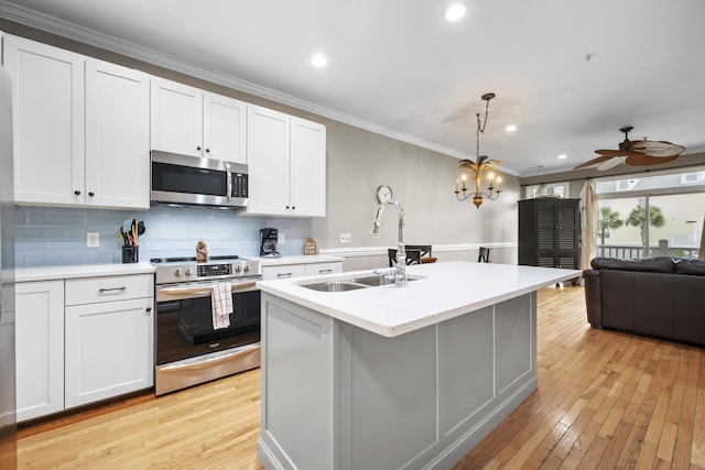 81 Sandbar Ln Unit 23, Folly Beach, SC 29439 - kitchen featuring appliances with stainless steel finishes, ornamental molding, light countertops, light wood-style floors, and decorative backsplash