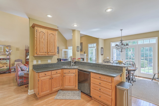 kitchen with sink, a notable chandelier, decorative light fixtures, stainless steel dishwasher, and light hardwood / wood-style floors