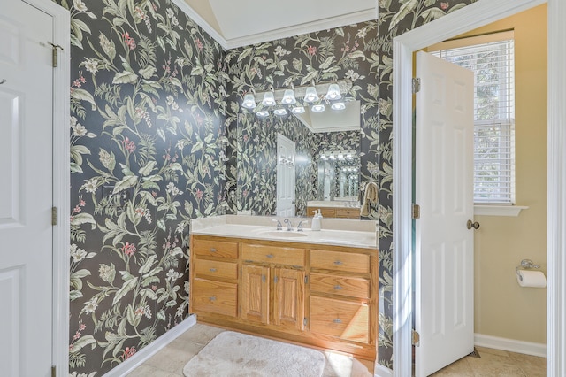 bathroom featuring vanity, crown molding, a healthy amount of sunlight, and tile patterned flooring