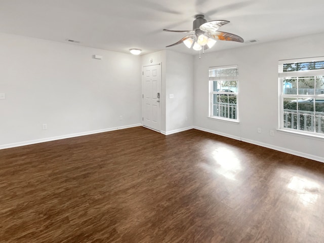 empty room with dark wood-type flooring and ceiling fan