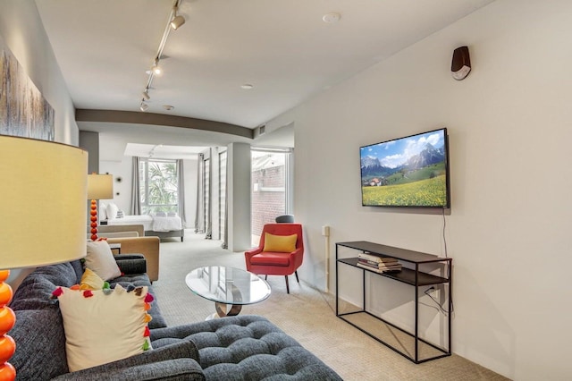 living room featuring light colored carpet and rail lighting