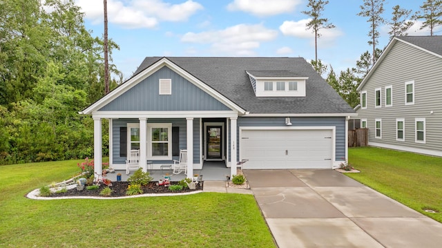 view of front of home with a porch, a garage, a front lawn, concrete driveway, and a shingled roof