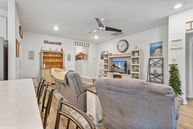 living area featuring light wood-style floors, a ceiling fan, recessed lighting, and baseboards