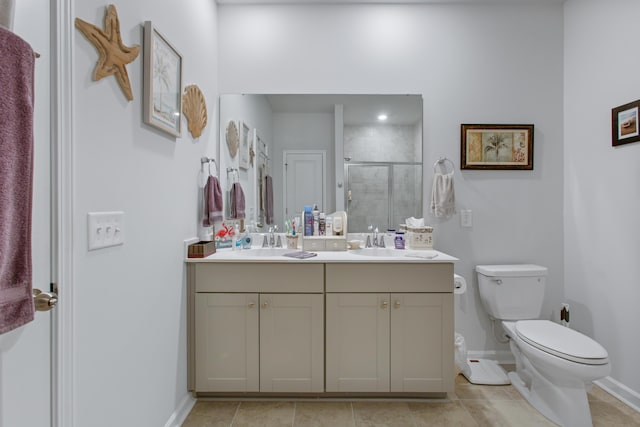 full bathroom with baseboards, a shower stall, toilet, double vanity, and tile patterned flooring