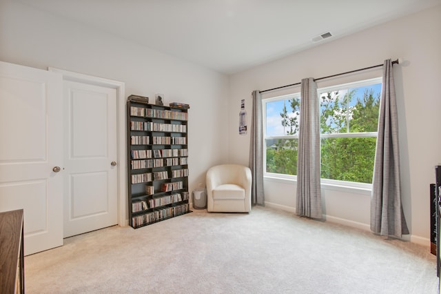 living area featuring carpet floors and baseboards