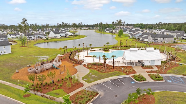 aerial perspective of suburban area with a large body of water and a pool