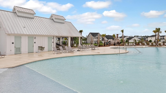 community pool featuring a residential view and a patio area