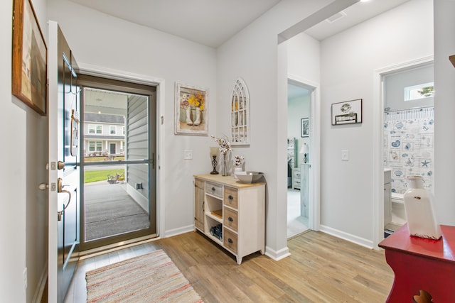 entryway featuring light wood finished floors and baseboards