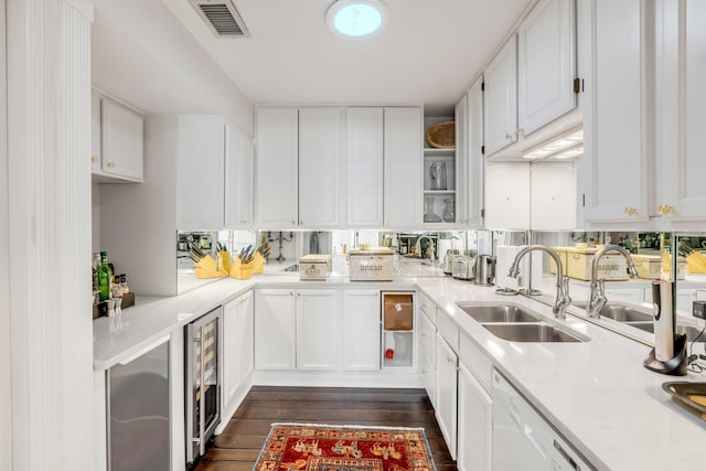 kitchen with white cabinets, dark hardwood / wood-style floors, sink, and wine cooler