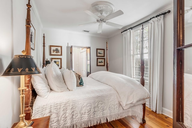 bedroom with ceiling fan, crown molding, and light hardwood / wood-style flooring