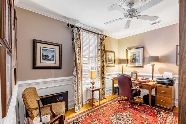 office area with ceiling fan, wood-type flooring, and ornamental molding