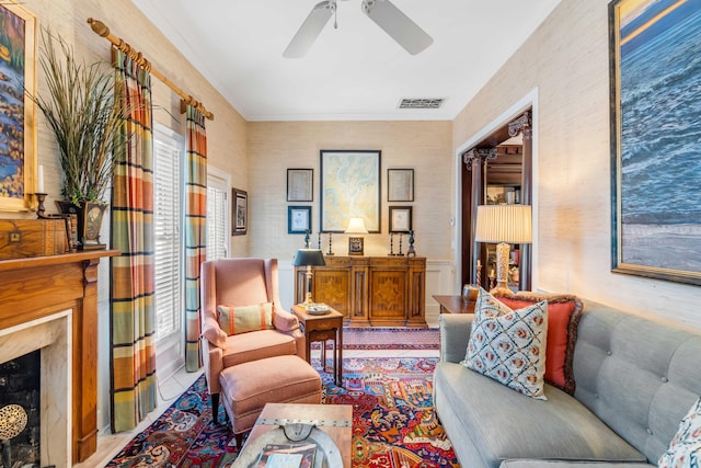 living room featuring crown molding and a fireplace