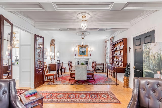 dining area featuring crown molding, an inviting chandelier, and parquet flooring