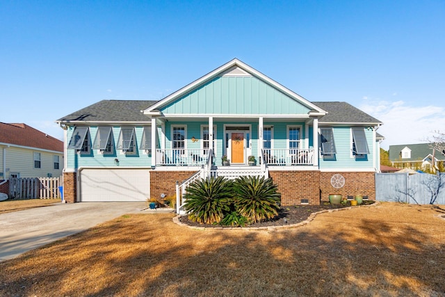 view of front facade featuring a garage, a front yard, and covered porch