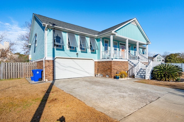 view of front facade with a garage, a front lawn, and a porch