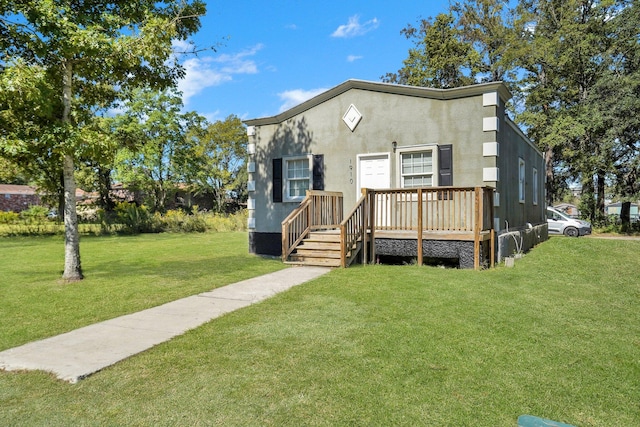 view of front of home with a front lawn and a wooden deck