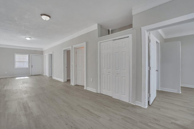 interior space featuring ornamental molding and light hardwood / wood-style flooring