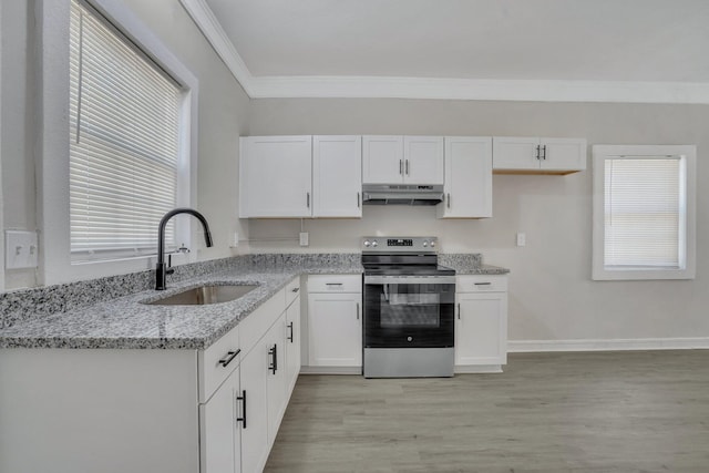 kitchen with light wood-type flooring, electric range, sink, light stone countertops, and white cabinetry